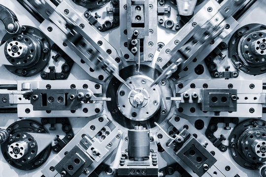 complex industrial machine with metal parts, bolts, and precision tools. Symmetrical design shows mechanical beauty in manufacturing