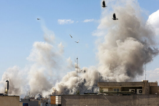 Explosion smoke billows over Tehran cityscape