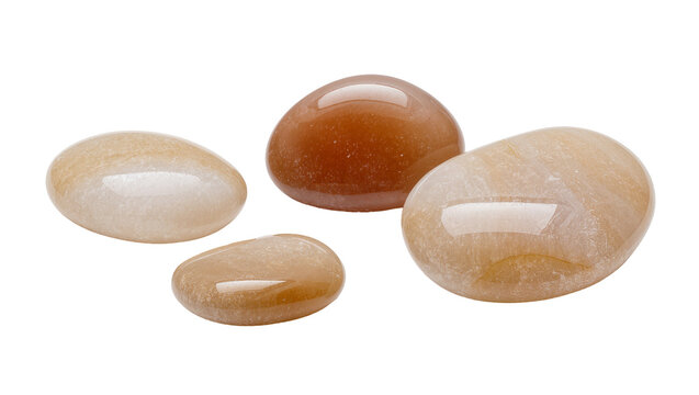 Isolated group of natural polished gemstones, smooth mineral stones in earthy orange and beige tones.
