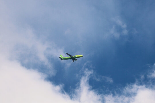 MOSCOW, RUSSIA - APRIL 2, 2026: Bright green S7 Airlines passenger plane flying in clear sky
