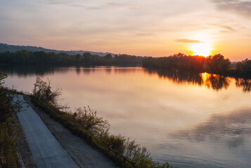 Sunset over the waters of Po river in the outskirts of the city of Casale Monferrato (Piedmont Northern Italy) capital of the same name winery region (UNESCO site). © stefanopez
