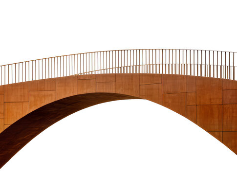 Isolated modern architectural arched bridge detail featuring a curved railing and textured metal