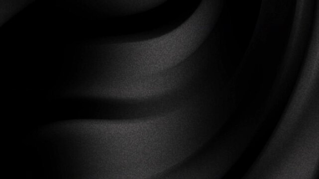 Grainy gradient smooth black fabric texture folds ideal for backgrounds, clothing design, fashion presentations, and minimalist graphic design projects.