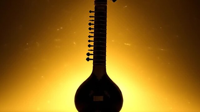 Silhouette of a Sitar musical instrument against a warm golden background.