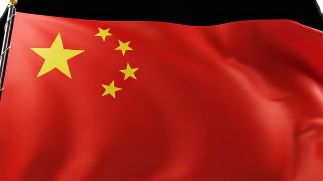 Close-up view of the red national flag of the People's Republic of China waving on a flagpole against a dark background, showing five golden stars and fabric texture