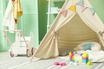 Cute wigwam and building blocks in stylish child's room © New Africa