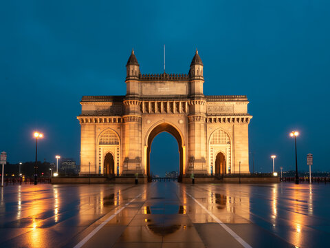 The majestic gate of india at dusk with a reflective water body in the foreground.
