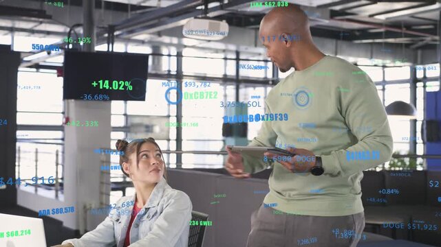 Standing man entering frame holding tablet, tapping laptop and guiding peer to show crypto overlays