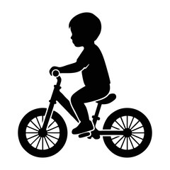 Obraz premium silhouette of a small child riding a balance bike