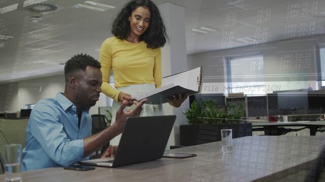Woman coming with file showing docs while man using laptop working in office overlays passive right