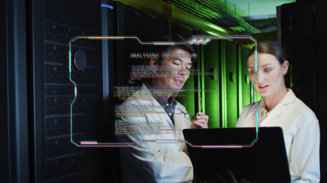 Glitching HUD appearing, two technicians consulting laptop, gesturing and diagnosing server issue