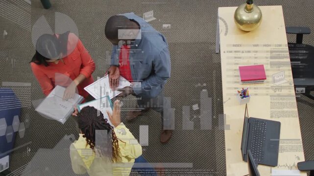 Yellow staffer placing hand starting review with team, clarifying docs in office, overlays on docs
