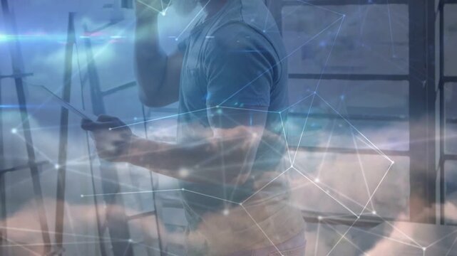 Man receiving call, consulting tablet and referencing data while tapping, cloud overlays drifting