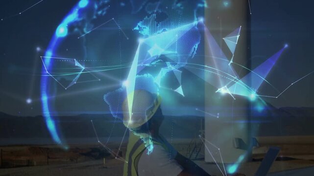 Field tech using laptop at energy tower base as animated nodes forming globe, monitoring data