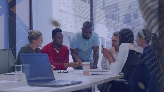 Business team leaning at table, lead pointing docs, spurring review while glass dots crossing view