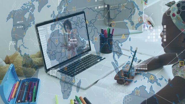 Girl watching laptop education lesson, writing while world map data overlays layering across paper