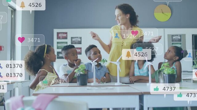 Teacher explaining science project at table, animated alerts filling scene over turbines and plants