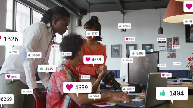 Floating likes badges appearing team leaning over laptop pointing holding DSLR tracking reach