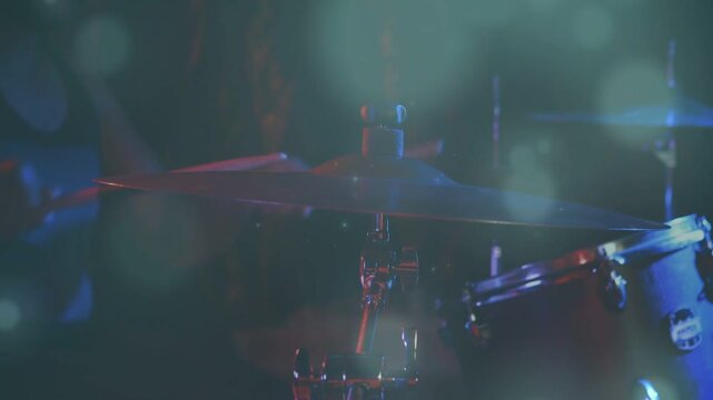 Drummer starting stick touching, striking cymbal and tom while animated wave overlaying light music