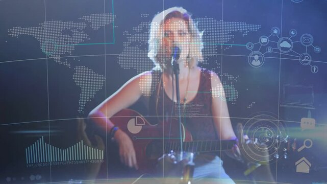Reacting to raised hands, teen female singer strumming guitar and singing onstage with HUD overlays