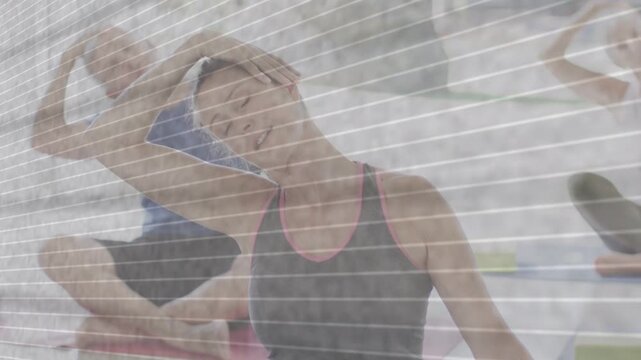 Woman following fitness cue tilting reaching up on mats seeking mobility striped overlay softening