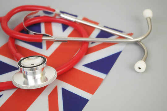 Red stethoscope on flag of UK. British medicine and health insurance concept.