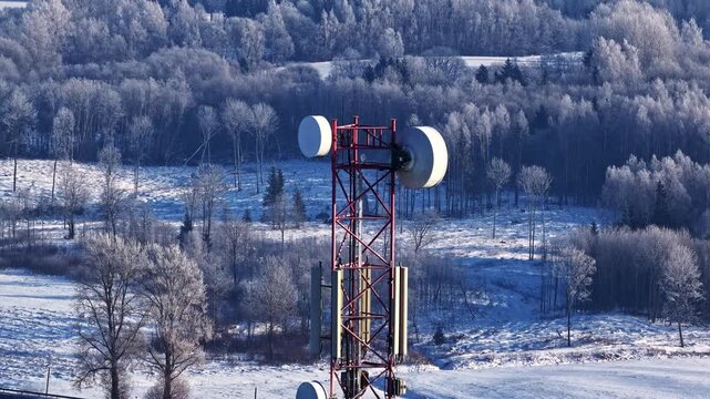 Drone orbiting around cell tower, high altitude 180 degree winter panorama in Latvia