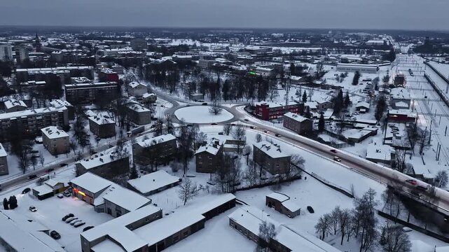 Snow covered landscape near Jelgava train station, heavy winter in Latvia aerial drone view