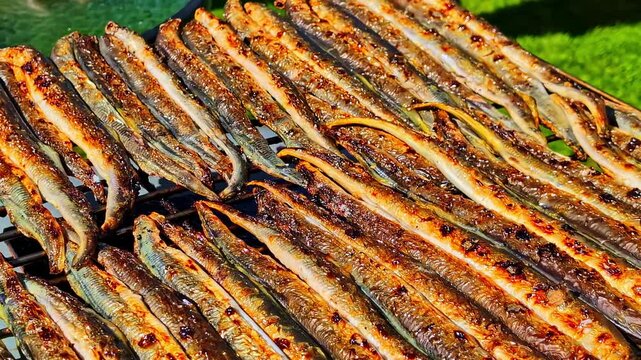 Grilled eels sizzling on barbeque, savory outdoor cooking concept