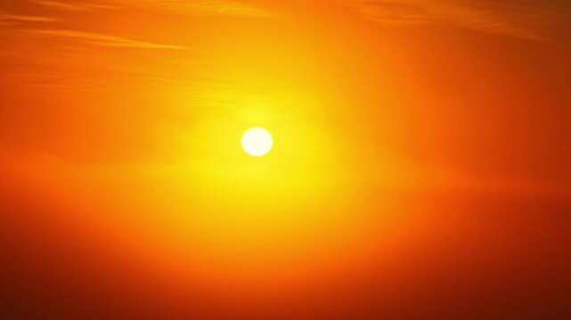 Aerial drone flying toward glowing orange sunrise as clouds slowly appear beneath the bright horizon.