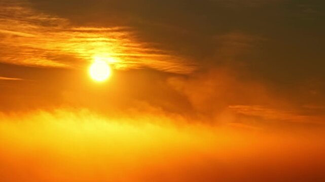 Glowing sun over a golden sea of clouds at sunrise, warm atmospheric sky with soft haze and strong copy space for backgrounds and cinematic travel visuals.