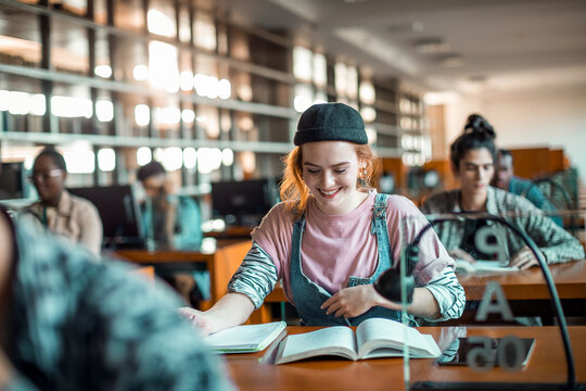 Smiling college student studying in university library