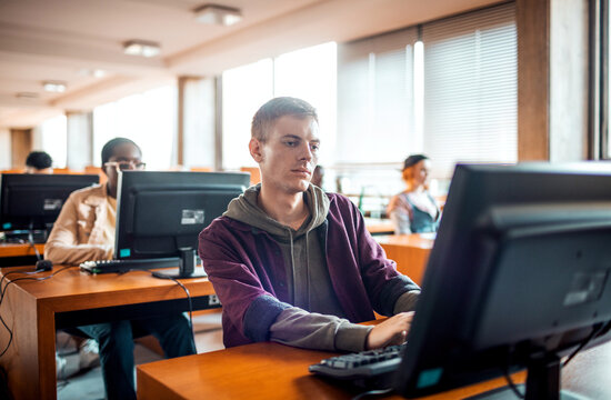 College students studying on desktop computers in campus lab