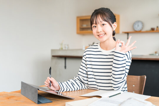 Elementary and middle school girls using tablets to study and do homework (OK, good grades)