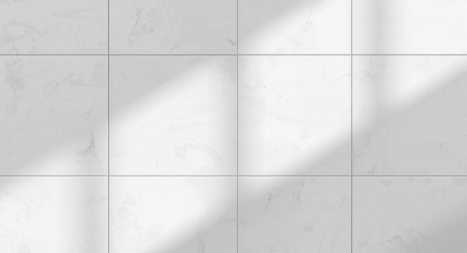 White wall tile surface with minimal rough finish lit by soft daylight providing copy space