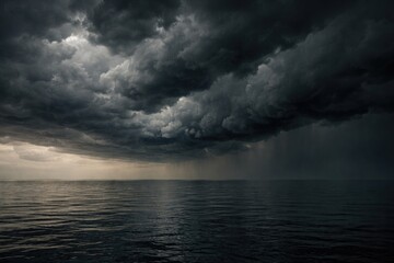 Fototapeta premium Stormy dark clouds looming over calm horizon with muted tones