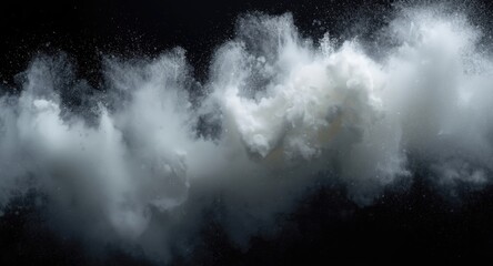 Fototapeta premium White powder plume spreading wide over a black background with copy space