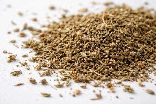 Close up view of dried thyme herbs scattered on a clean white surface