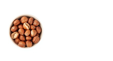 Obraz premium White background image showing a ceramic bowl filled with edible hazelnuts
