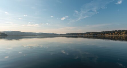Fototapeta premium still waters of a lake beneath a peaceful sky