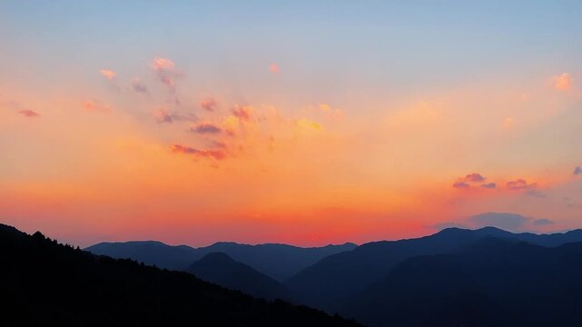 Serene horizontal timelapse of a soft orange sunset fading over a quiet mountain valley. The sky transitions through beautiful warm tones as clouds drift slowly.