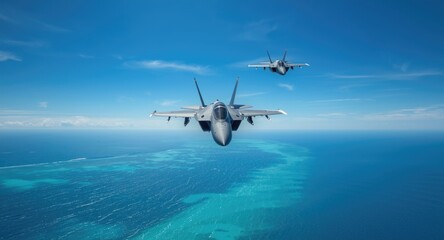 Naklejka premium Two sleek military jets flying above turquoise ocean waters