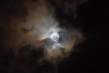 Full moon in the dark sky with clouds © ric