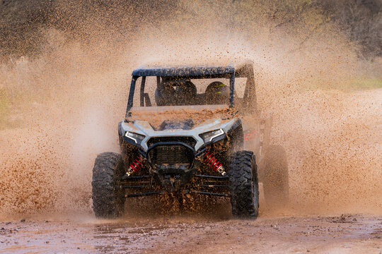 ATV Charging Through Mud Splash in High-Speed Off-Road Action