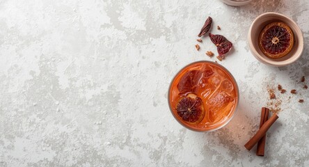 Fototapeta premium White grunge textured backdrop featuring a refreshing cocktail with dried fruit and cinnamon sticks for party settings