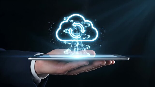 A human hand holding a tablet displaying a glowing blue cloud icon with refresh arrows above it.
