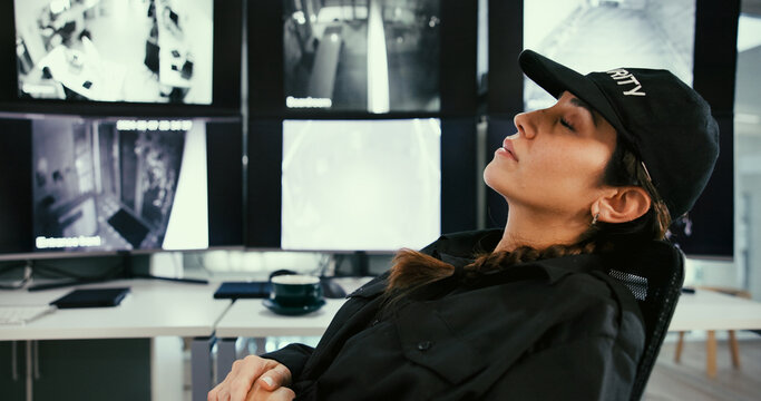 Sleeping, security and tired woman in control room with fatigue, narcolepsy or slacker. Female guard, nap and workplace with burnout by computer surveillance, screen or technology for safety on shift