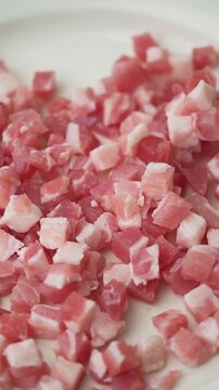 Rotating diced pancetta close up