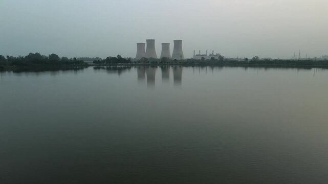 Symmetrical Reflection of Thermal Power Plant Cooling Towers in Bathinda Lake at Dusk.
