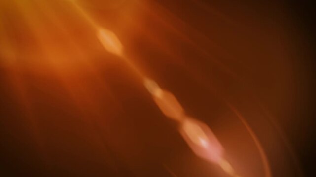 Orange light flash streaks across dark background